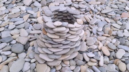a tower built of stones on the seashoreの写真素材