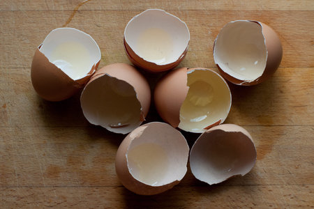 shell eggs from seven halves lie on a chopping board