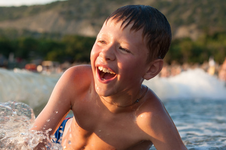 boy is bathed in a sea of cheerful and happy eveningの写真素材
