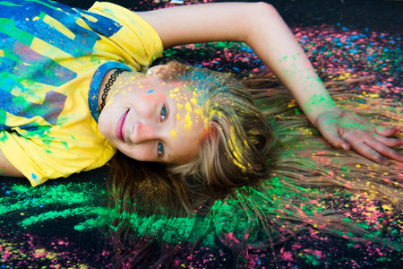 Woman in nature paint sprinkled Holi summer