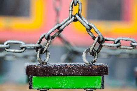 iron chain on the playground in the winter clear day