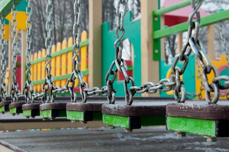 iron chain on the playground in the winter clear dayの写真素材