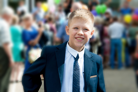 The boy in a suit near the schoolの写真素材