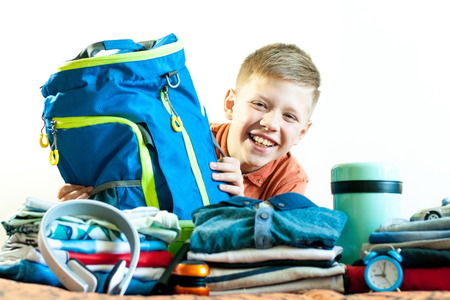 The boy on the background of his things hugged the bagの写真素材