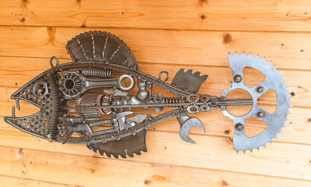 Old rusty gears and sprockets on a wooden background, top viewの写真素材