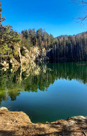 lake in deep forest with trees and sandstone cliffs, nature seriesの写真素材