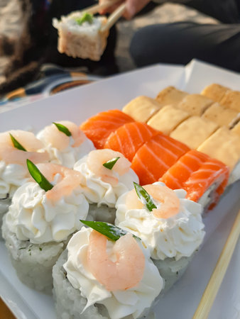 Sushi set with salmon, shrimp and cream cheese on white plateの写真素材