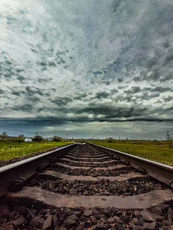 railway track with cloudy sky in the background, travel and transportation conceptの写真素材