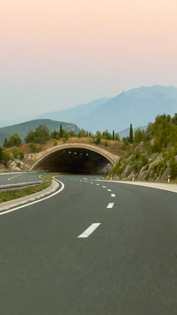 View of the road and tunnel through the big mountainの写真素材