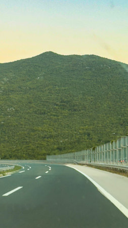 The view from the car on the road, the big mountain and the beautiful sky