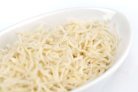 Grated cheese on the white plateの写真素材