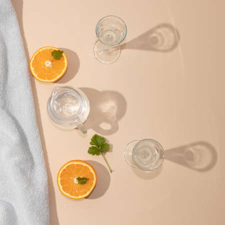 Summer arrangement with bright blue beach towel and fresh cold drink. Palm leaf shadow.の写真素材