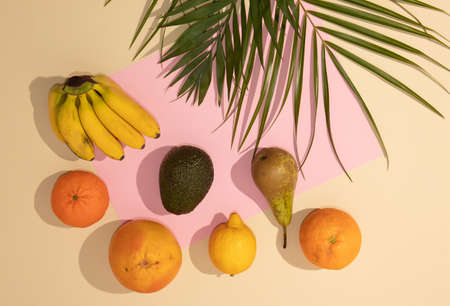 Summer tropical composition with fresh organic fruit with palm leaves. Flat lay food.の写真素材