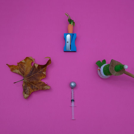 Autumn leaf combined with Snowman, , vitamins on a pink background. Minimal flat lay composition.の写真素材