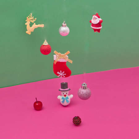 Snowman and Santa Claus surrounded by New Year's decorations on a green-pink background. New Year's scene.の写真素材