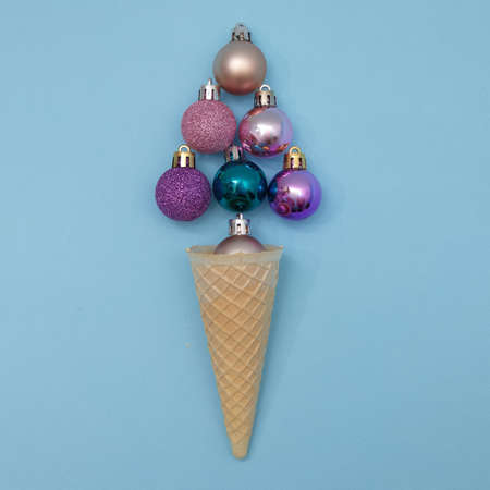 Ice cream from New Year's decorations in a cone, similar to a New Year's tree. Minimal scene, flat lay.の写真素材