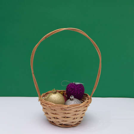 Basket with New Year's decorations on a green-white background. New Year's scene.の写真素材