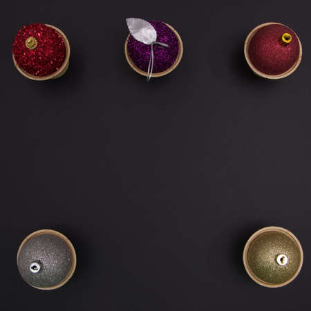 New Year's balls in cones on a black background with copy space. Minimalistic flat lay scene.の写真素材
