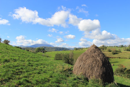 Haystack stands in a serene countryside view.の写真素材
