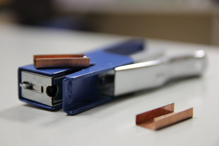 Close-up of a metal punch tool and strips.