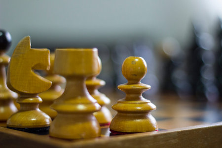 A yellow chessboard and its pieces evoke the timelessness of a classic game, bringing to mind the...