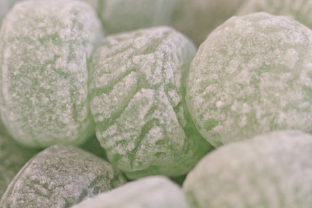A swirl of green-tinted candy, glistening with sweetness, fills the frame, creating a tantalizingly mouth-watering feast for the eyesの写真素材