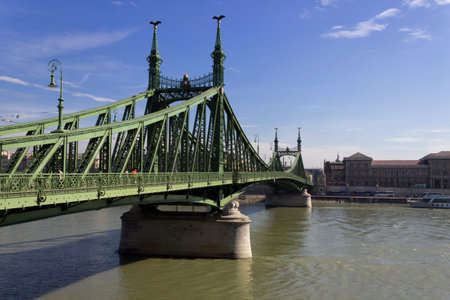 People stroll on the iconic green bridge.の写真素材