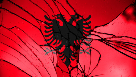 Flag of Albania, Albanian flag painted on broken glassの写真素材