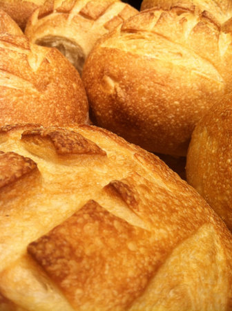 a grouping of fresh baked organic sourdough boule bread