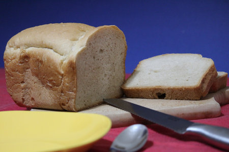 Freshly baked bread on red kitchen tableの写真素材