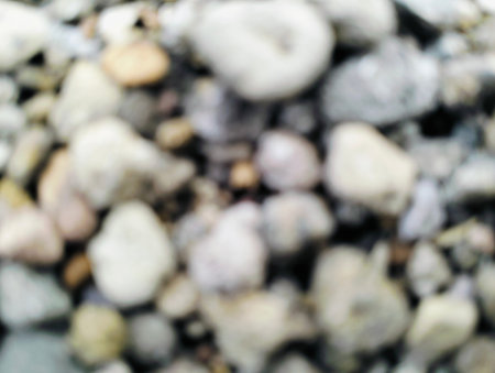 Close up of pebbles and rocks with blurry background, Natural stones background, wallpaper out of focus.の写真素材