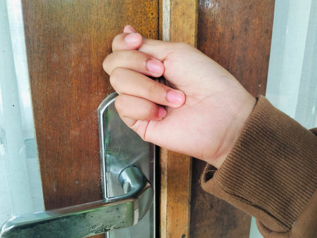 Hand knocking on a wooden door, Close up Knocking on the door, a woman's hand knocks on a wooden door, a visit to visit.の写真素材