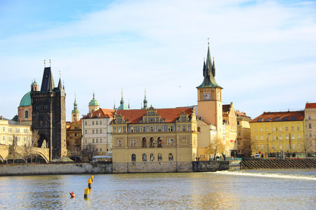 An old house with a tower on the river bank near the Charles Bridge in Pragueの写真素材