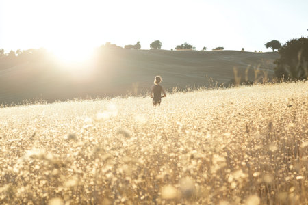 Vibrant scene of individual engaging in fitness routine in a bright sunlit fieldの素材