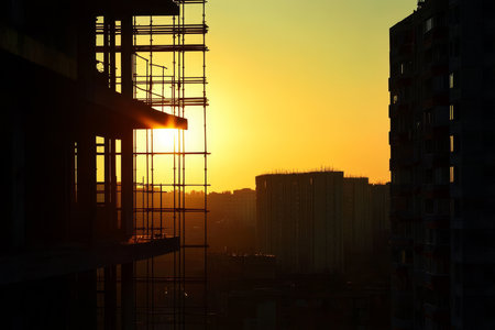 Silhouette of a construction site at sunset with space for architecture and project developmentの写真素材