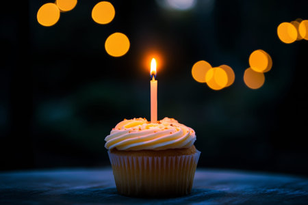 Delightful birthday cupcake topped with a single candle for a special celebrationの写真素材