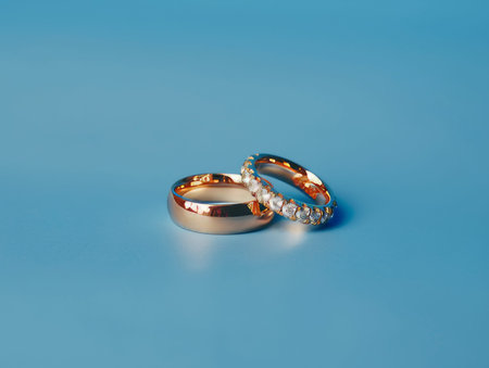 Stunning wedding gold rings displayed elegantly against a striking blue background