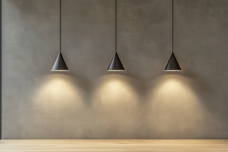 Minimalist modern indoor space with industrial pendant lights and light wood flooringの写真素材