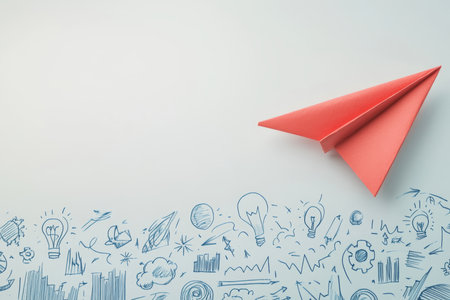 Minimalist design featuring a red paper airplane and blue doodles on a bright white backgroundの写真素材
