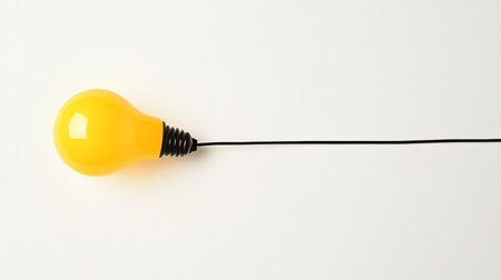 Yellow light bulb on white background symbolizing creativity and innovation in new ideasの写真素材