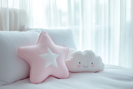 Close up of white bed with pink star and cloud pillows against blurred white curtain backdropの写真素材