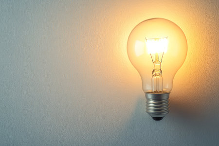 Soft pastel light bulb photography with subtle shading on a clean white backgroundの写真素材