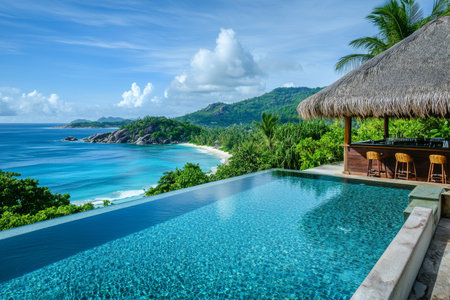 Luxury infinity pool with beach view in seychelles surrounded by tropical trees and barの写真素材