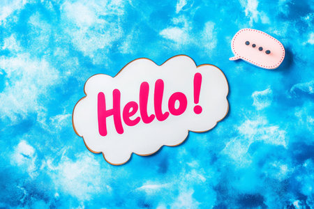 Speech bubble featuring hello on a blue background with copy space for text on web bannerの写真素材