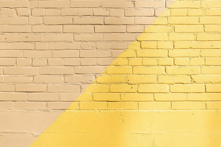 Close up of a beautiful soft yellow and beige brick wall in a flat lay perspectiveの写真素材