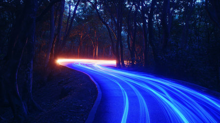 Futuristic night photography blue light trails from fast moving cars on a forest roadの写真素材