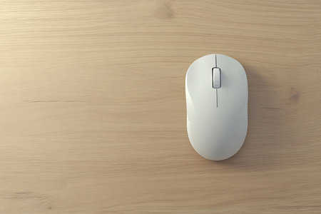 Photorealistic aerial view of a computer mouse on a light wooden table backgroundの写真素材