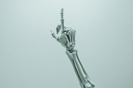 Minimalist design of a skeletal hand pointing upward against a light gray background