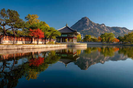 Stunning autumn panorama of gyeongbokgung palace lake with mountains and traditional Korean houseの写真素材