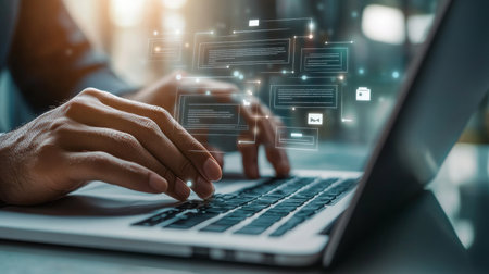 Businessman engaged in laptop work with floating digital forms and icons on transparent screenの写真素材